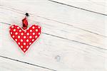 Valentines day background with toy heart over white wooden table background