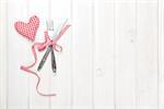 Valentines day heart shaped toy gift and silverware. View from above over white wooden table with copy space