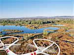 rotating propellers of a helicopter drone flying over lake and swamp landscape in northern Colorado