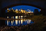 Evening river flowing under the bridge in the city