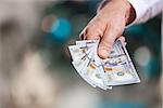 Hand with money on a blurred background