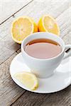 Green tea with lemon on wooden table