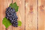 Bunch of red grapes on wooden table background with copy space