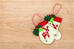 Christmas mitten decor on wooden background with copy space