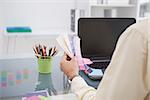 Designer working at his desk with colour sample in his office