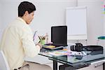 Designer using digitizer and colour sample in his office