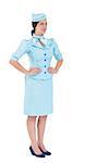 Pretty air hostess with hands on hips on white background