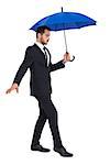 Concentrated businessman holding umbrella while stepping on white background