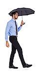 Focused businessman under umbrella stepping on white background