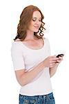 Pretty redhead sending text message on white background