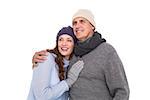 Couple in warm clothing embracing on white background