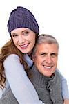 Happy couple in warm clothing on white background