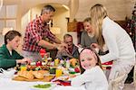 Three generation family having christmas dinner together at home in the living room