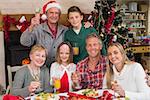 Family toasting with white wine in a christmas dinner at home in the living room