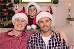 Son joking to his father and grandfather at home in the living room