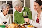 Senior couple laughing at christmas dinner at home in the lliving room