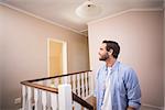 Casual man walking up the stairs in his new home