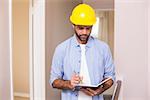 Casual architect reading his notes in a new house