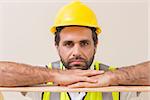 Stern construction worker looking at camera in a new house