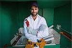 Construction worker shrugging at camera  in a new house