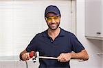 Plumber fixing pipe with wrench in the kitchen