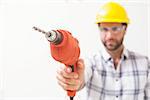 Construction worker holding power drill in a new house