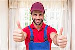 Construction worker showing thumbs up in a new house