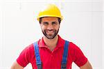Construction worker smiling at camera in a new house