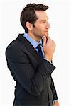 Thinking businessman touching his chin on white background