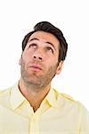 Handsome man in shirt looking up on white background