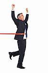 Happy businessman crossing finishing line on white background