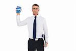 Businessman showing calculator while holding his laptop on white background