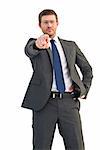 Frowning businessman pointing at camera on white background
