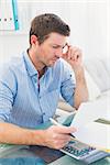 Businessman reading document at his desk in his office in his office