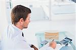 Businessman working on his finances at his desk in his office