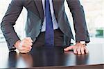 Angry businessman thump the table in his office