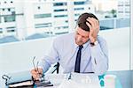 Businessman looking at documents in his office