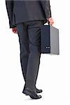 Rear view of businessman holding briefcase walking on white background