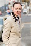 Young businesswoman smiling and walking outside in the city