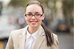 Young businesswoman looking at camera outside in the city