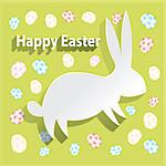 Paper easter bunny on green background with decorative eggs
