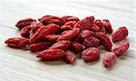 Heap of Dry Goji Berries on the Wooden Table. Healthy Diet