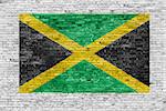Flag of Jamaica painted over white brick wall
