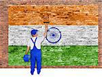 House painter covers old  brick wall with flag of India