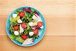 Fresh healthy salad on wooden table with copy space