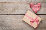 Valentines day toy heart and gift box over wooden table background