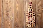 Wine bottle shaped corks over rustic wooden table background. View from above with copy space