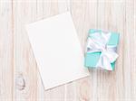 Valentines day gift box and greeting card on white wooden table with copy space