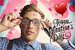 Geeky hipster covered in kisses against valentines heart design