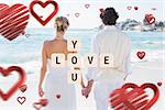 Bride and groom holding hands looking out to sea against love you tiles
